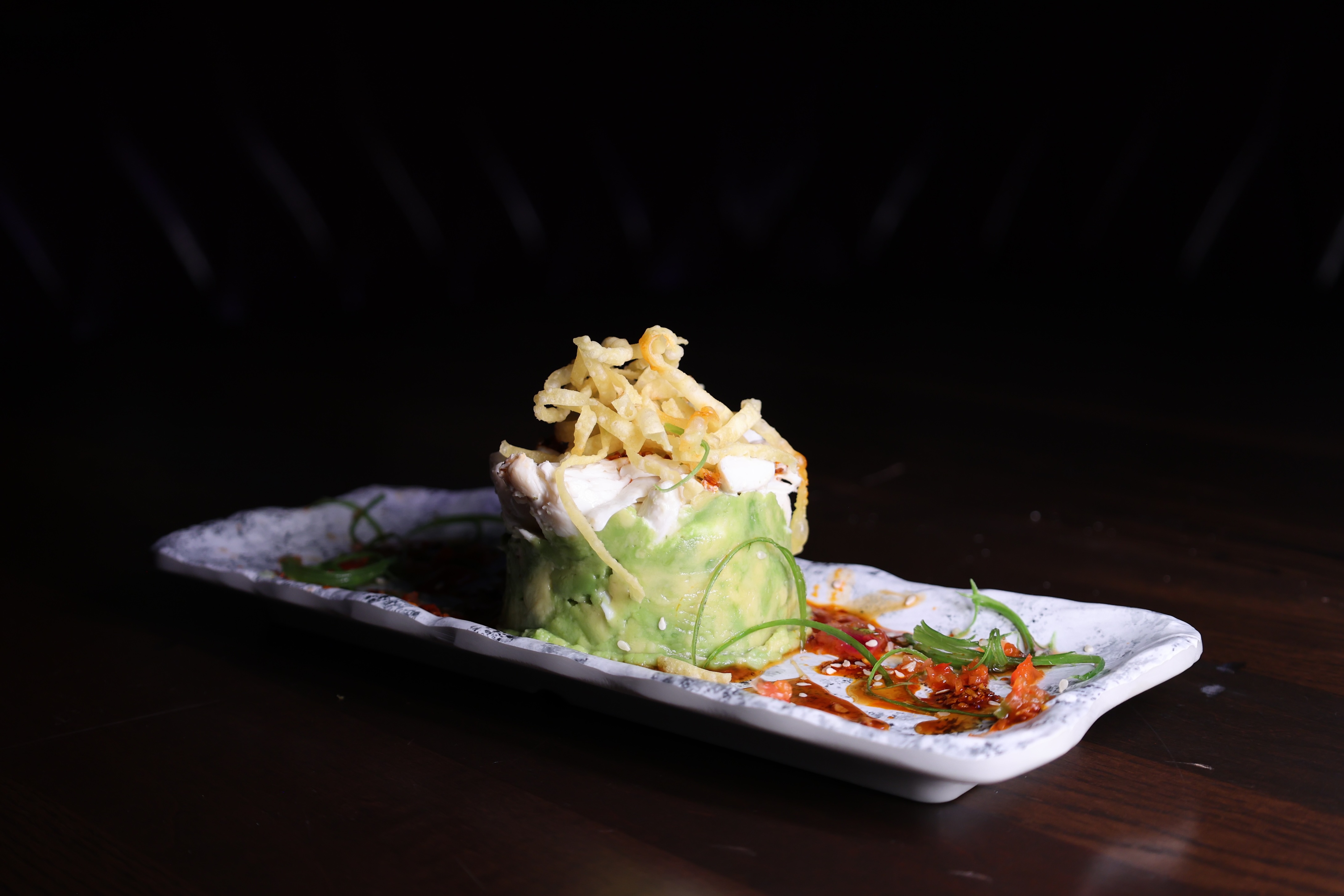 A Bad Rabbit small plate, shot dark and close on marble.